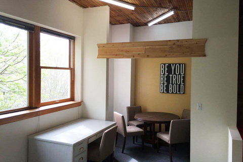 a room filled with furniture and a large window