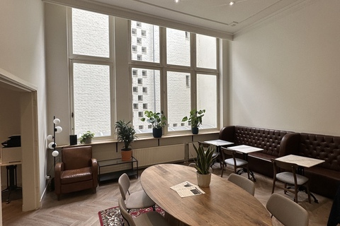 a view of a living room filled with furniture and a large window