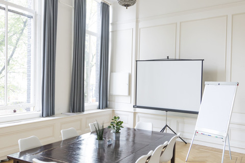 a dining room table in front of a window