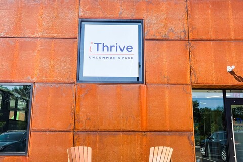 a bench in front of a brick building