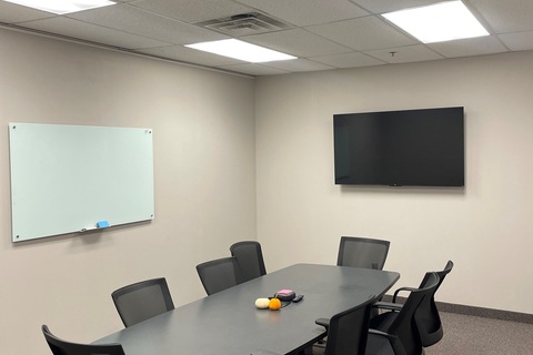 an office with a desk and chair in a room
