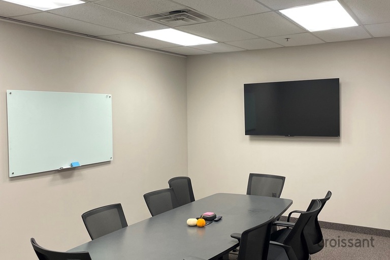 an office with a desk and chair in a room