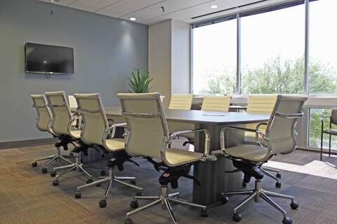 an office with a desk and chair in a room