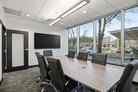 a conference room with a table and chairs