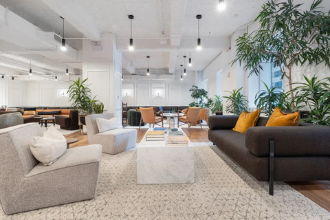 a living room filled with furniture and a large window