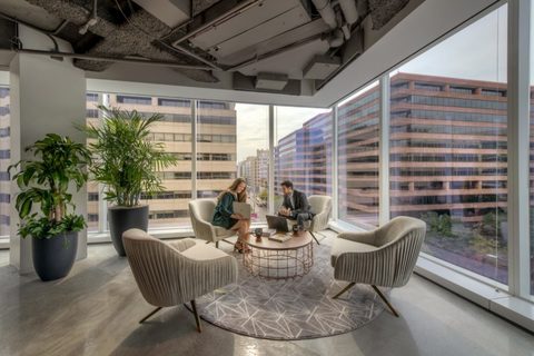 a living room filled with furniture and a large window
