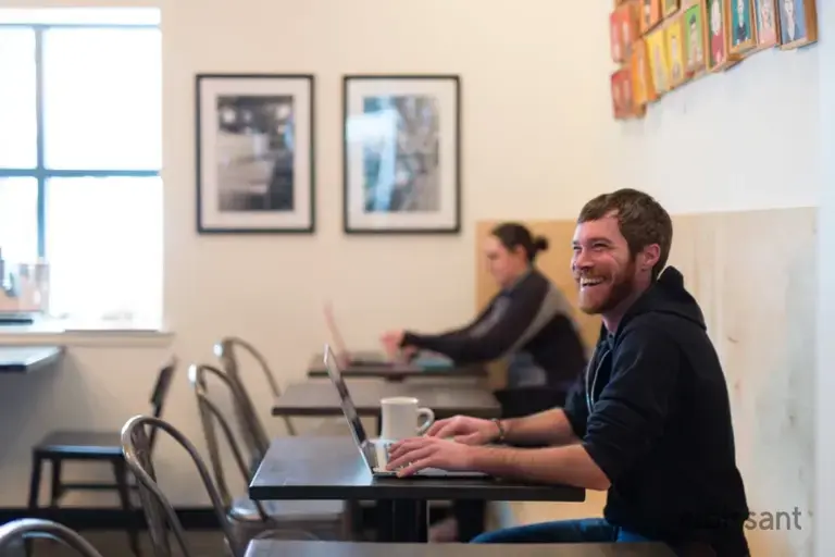 a man sitting at a table with a laptop