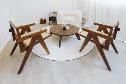 a chair sitting in front of a wooden table