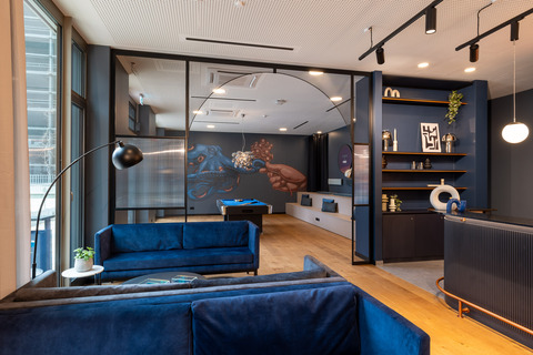 a living room with blue walls and a large window