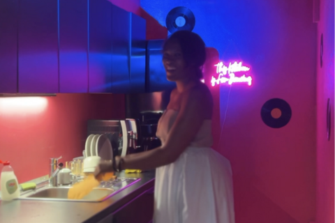 a woman washing dishes in a kitchen