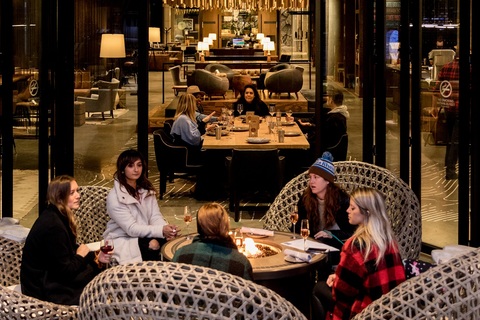 a group of people sitting in front of a store