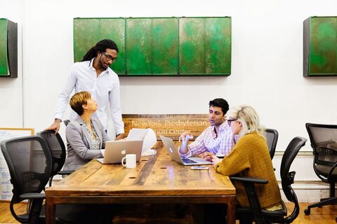 a group of people sitting at a table in a room
