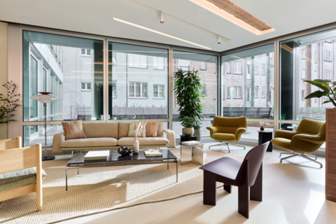 a living room filled with furniture and a large window