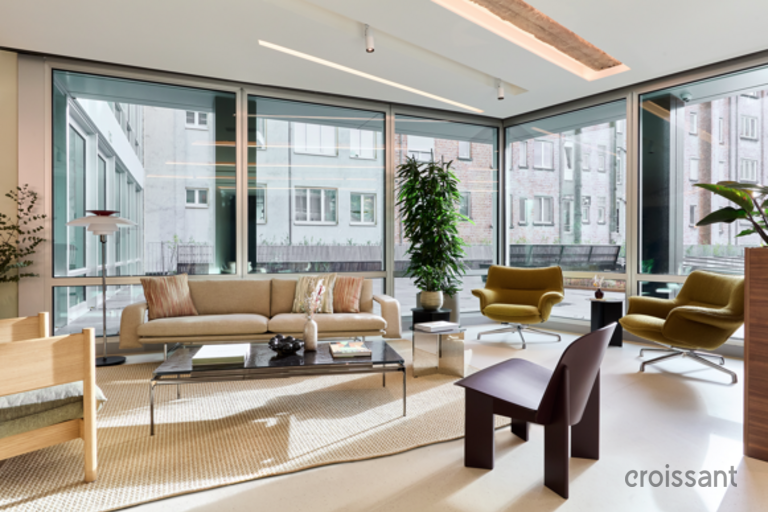 a living room filled with furniture and a large window
