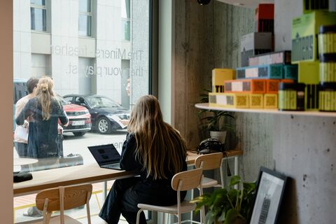 a person sitting at a table in front of a building