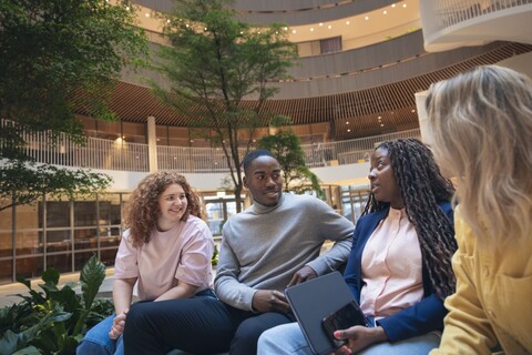 a group of people sitting on a bench
