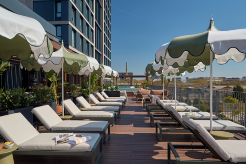 a deck with lounge chairs and umbrellas