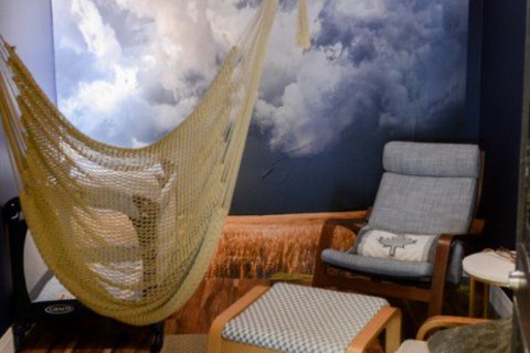 a bedroom with a bed and a chair in a room