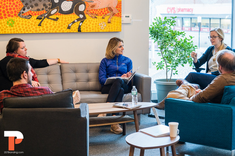 a group of people sitting around a living room