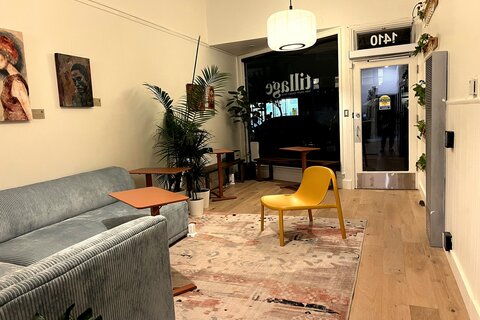 a room with a yellow chair and a rug
