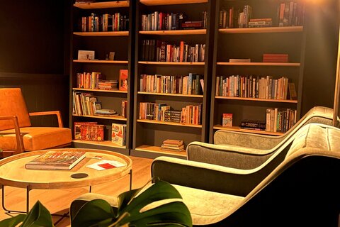 a room with bookshelves and chairs