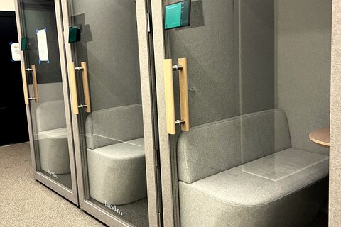 a group of glass doors with a bench