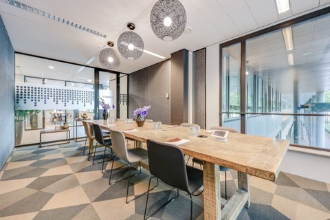 a kitchen with a table and chairs in a room
