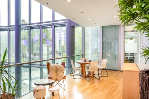 a living room filled with furniture and a large window