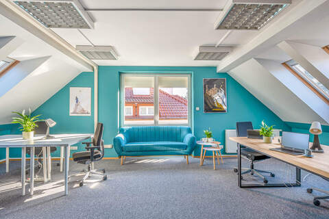 a room with a couch and desk