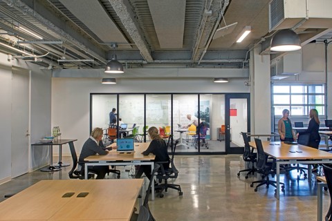 an office with a desk and chair in a room