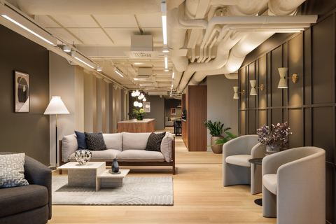 a room with a couch and chairs