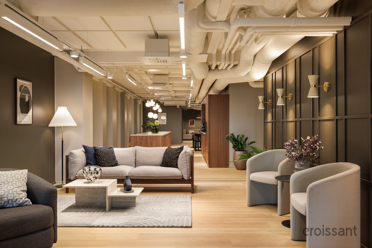 a room with a couch and chairs