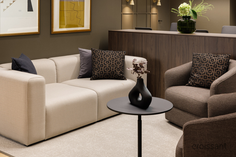 a room with a reception desk and couches