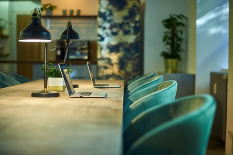 a desk with a laptop computer sitting on top of a table