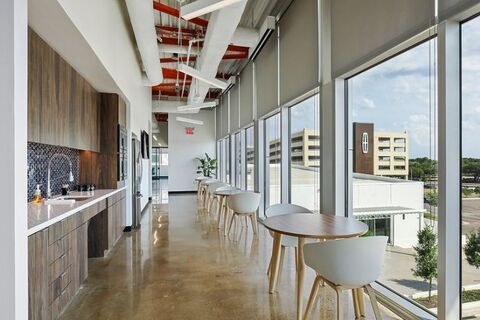 a room filled with furniture and a large window