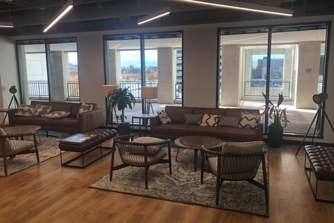 a living room filled with furniture and a large window