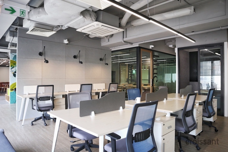 an office with a desk and chair in a room