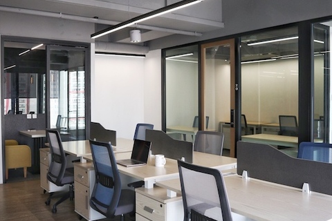an office with a desk and chair in a room