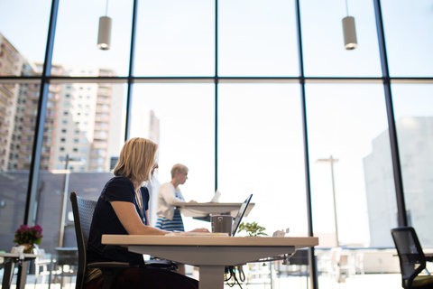 a person sitting at a table with a laptop