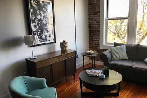 a living room filled with furniture and a large window