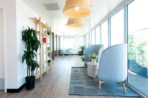 a living room filled with furniture and a large window