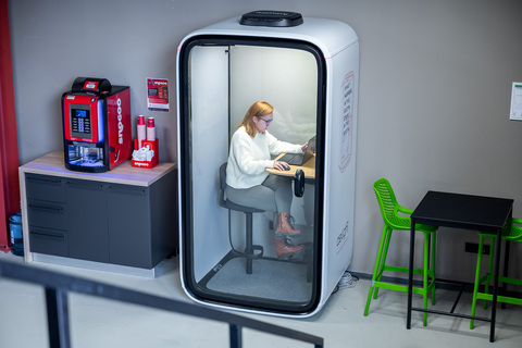a computer sitting on top of a refrigerator