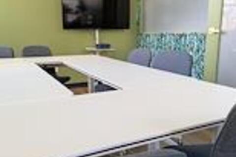 a room with a television and tables
