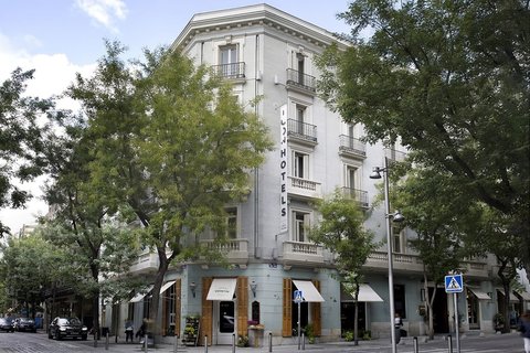 a group of people walking in front of a building