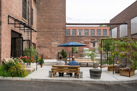 a bench in front of a brick building