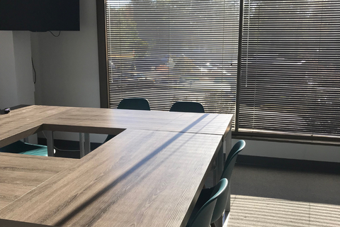 a bedroom with a bed and a chair in front of a window