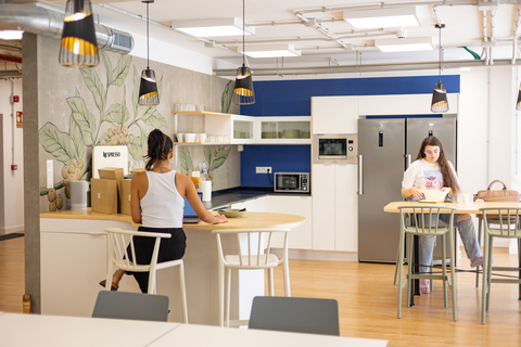 a group of people sitting at a table in a kitchen