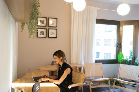 a woman sitting at a table using a laptop