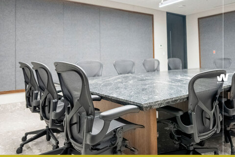 an office with a desk and chair in a room