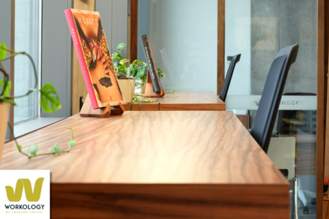 a desk with a laptop computer sitting on top of a wooden table